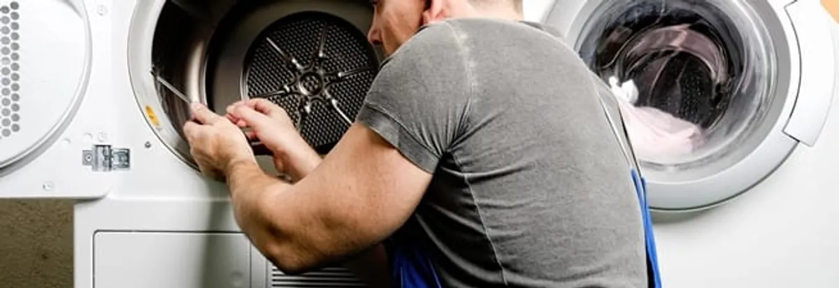 Dryer repair technician fixing a clothes dryer drum in Columbus, OH